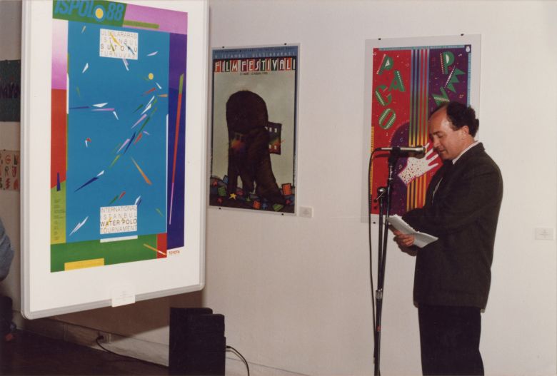 02 5 Sadık Karamustafa, <i>Türkiye’den Afişler </i>sergisinin açılış konuşmasını yaparken, York Quay Gallery, Toronto, Mayıs 1992
Salt Araştırma, Sadık Karamustafa Arşivi